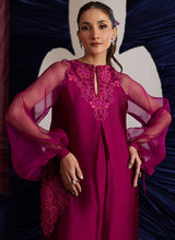 Load image into Gallery viewer, This magenta Sheesha Silk shirt is a stunning embodiment of contemporary elegance, seamlessly blending classical romance with modern flair. The shirt flows gracefully, adorned with delicate floral appliqués that add a soft, feminine touch, while meticulous embroidered details weave through the fabric, creating intricate patterns that enhance the shirt’s luxurious appeal. The statement balloon sleeves, tied with ribbons and bows, bring a dramatic, yet playful dimension to the design, adding volume and a sens