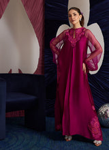 Load image into Gallery viewer, This magenta Sheesha Silk shirt is a stunning embodiment of contemporary elegance, seamlessly blending classical romance with modern flair. The shirt flows gracefully, adorned with delicate floral appliqués that add a soft, feminine touch, while meticulous embroidered details weave through the fabric, creating intricate patterns that enhance the shirt’s luxurious appeal. The statement balloon sleeves, tied with ribbons and bows, bring a dramatic, yet playful dimension to the design, adding volume and a sens